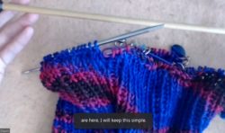 A contributor's knitting project in blue and red